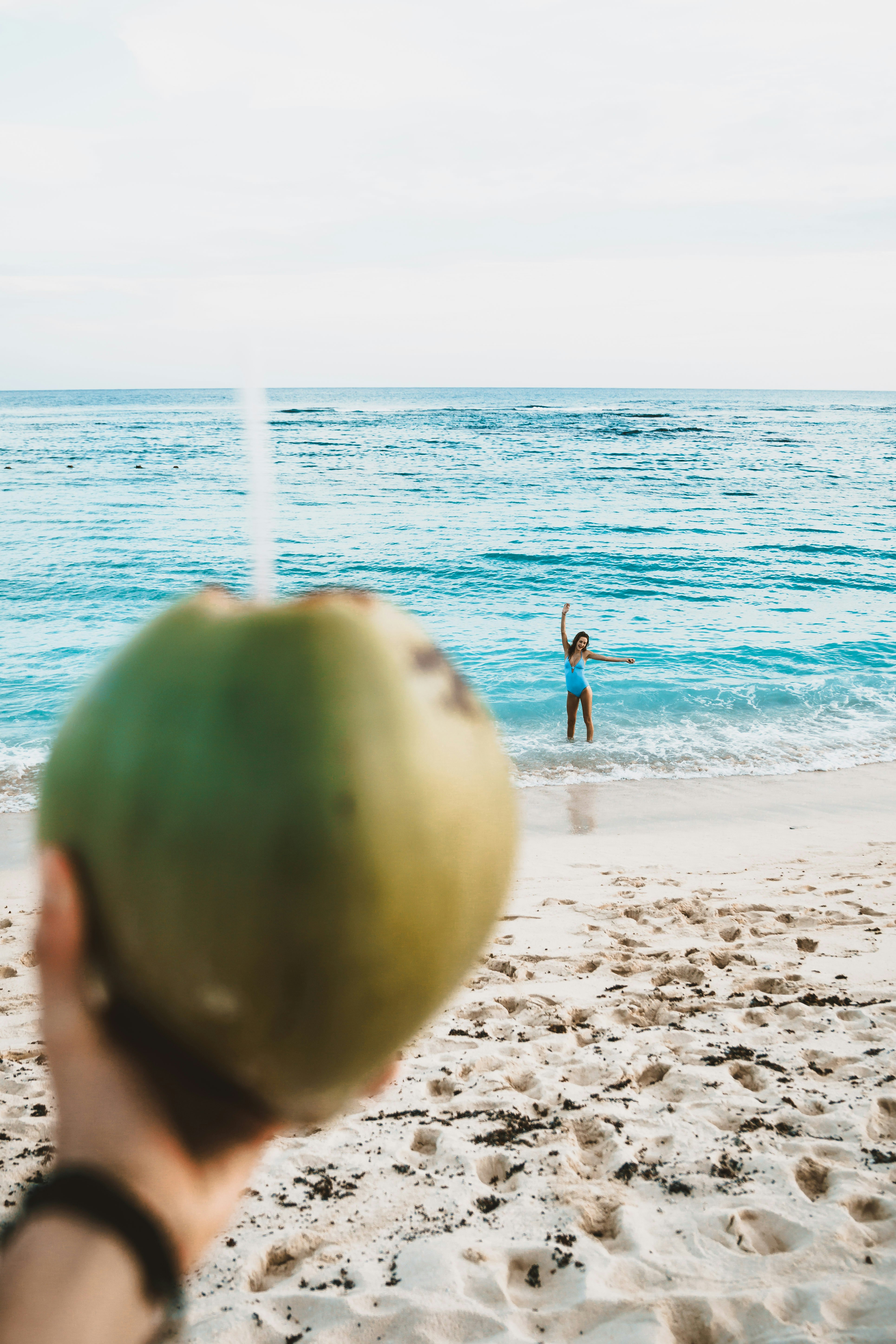 woman standing beside body of water